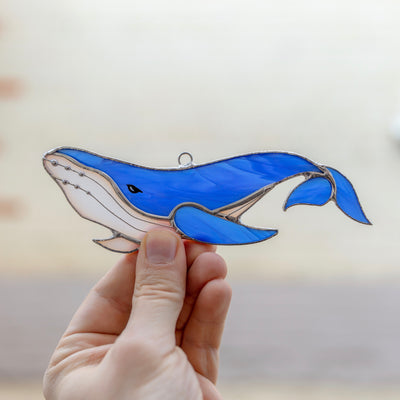 Stained glass whale with its tail down suncatcher of a royal blue colour