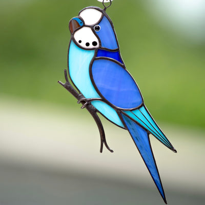 Blue parakeet on the branch suncatcher of stained glass