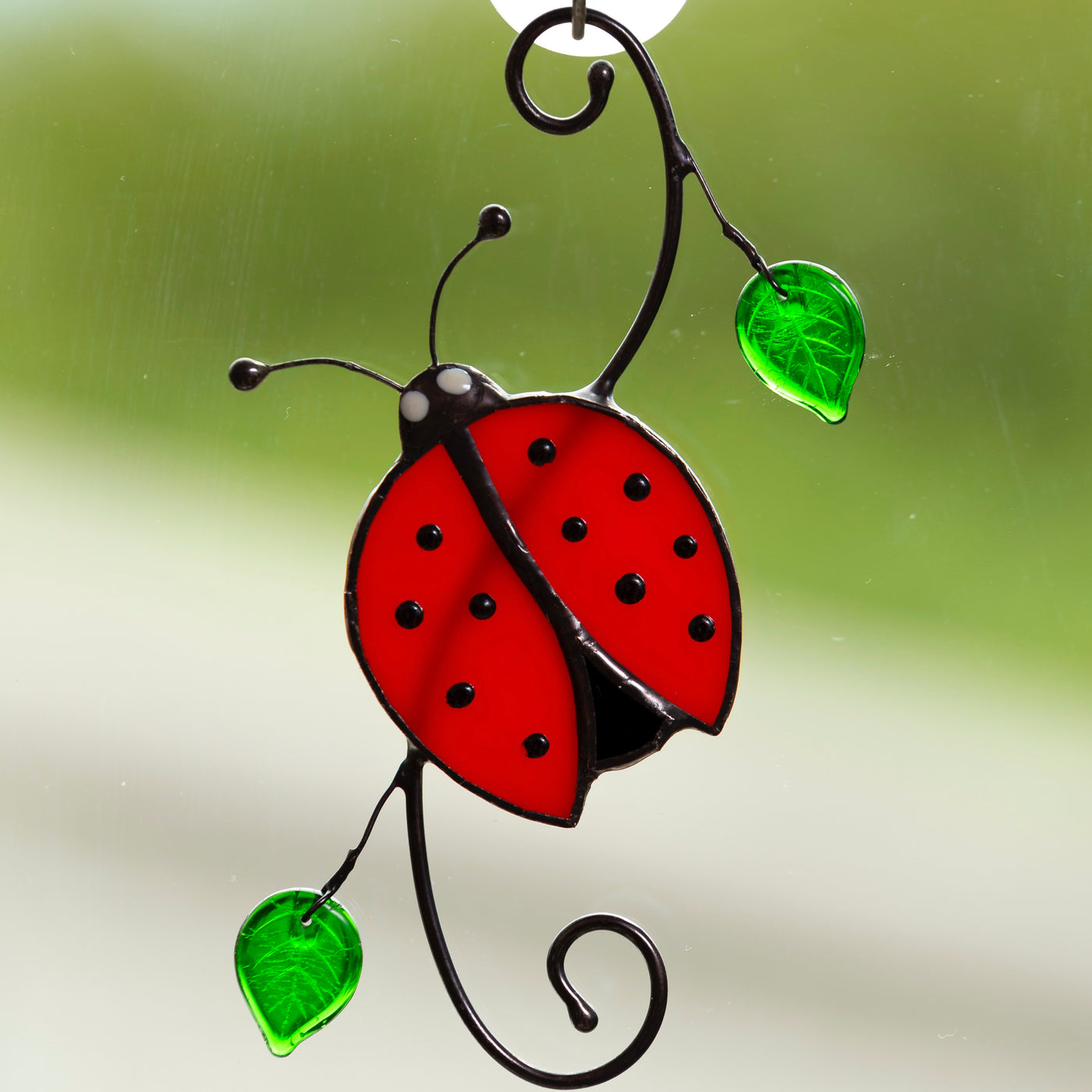 Stained glass ladybug on the branch suncatcher