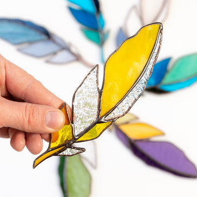 Stained glass yellow feather with clear parts suncatcher