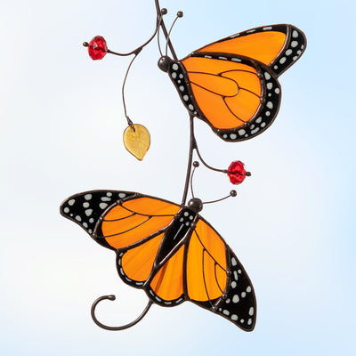 two monarch butterflies sitting on the branch stained glass suncatcher  Edit alt text