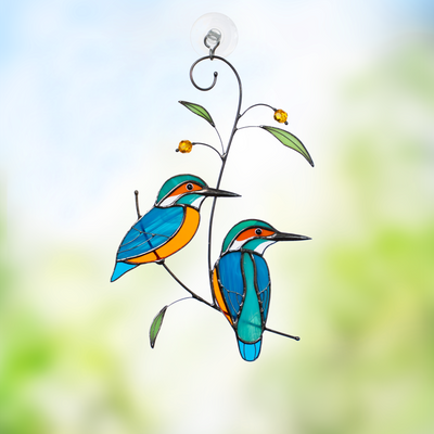 Couple of kingfishers sitting on the branch with leaves and berries window hanging of stained glass