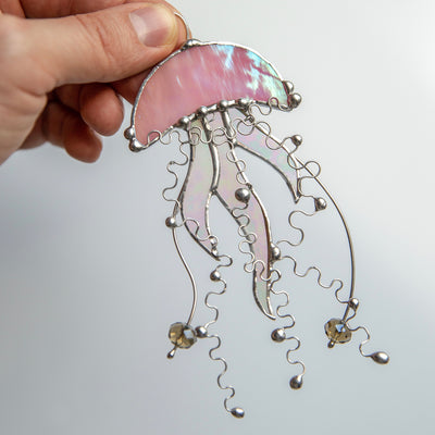 Pink stained glass jellyfish with iridescent tentacles window hanging
