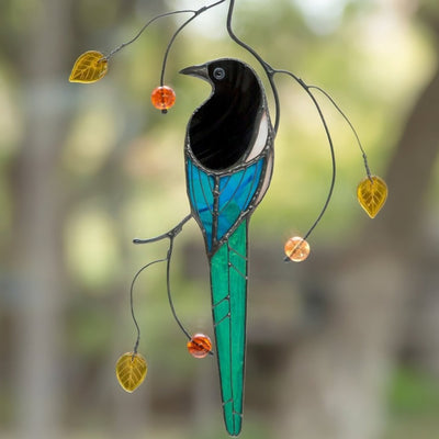 Zoomed stained glass magpie with long tail on the branch window hanging