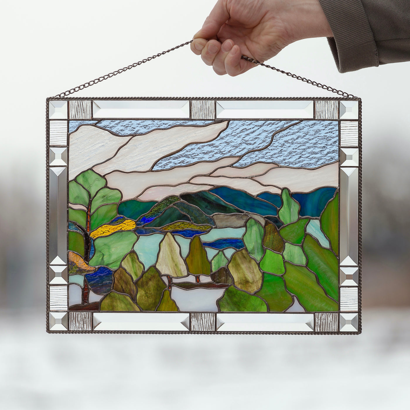 Stained glass panel depicting Estes Park with its mountains and flora