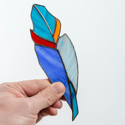 Stained glass blue feather suncatcher with red and orange parts 