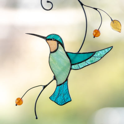 Stained glass hummingbird taking off the branch window hanging
