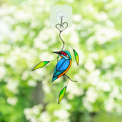 Stained glass window hanging of a kingfisher sitting on the branch