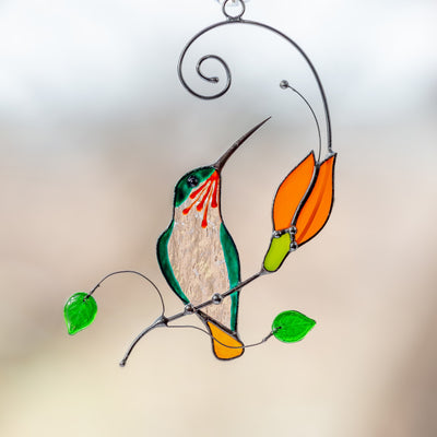 Stained glass hummingbird with orange flower suncatcher
