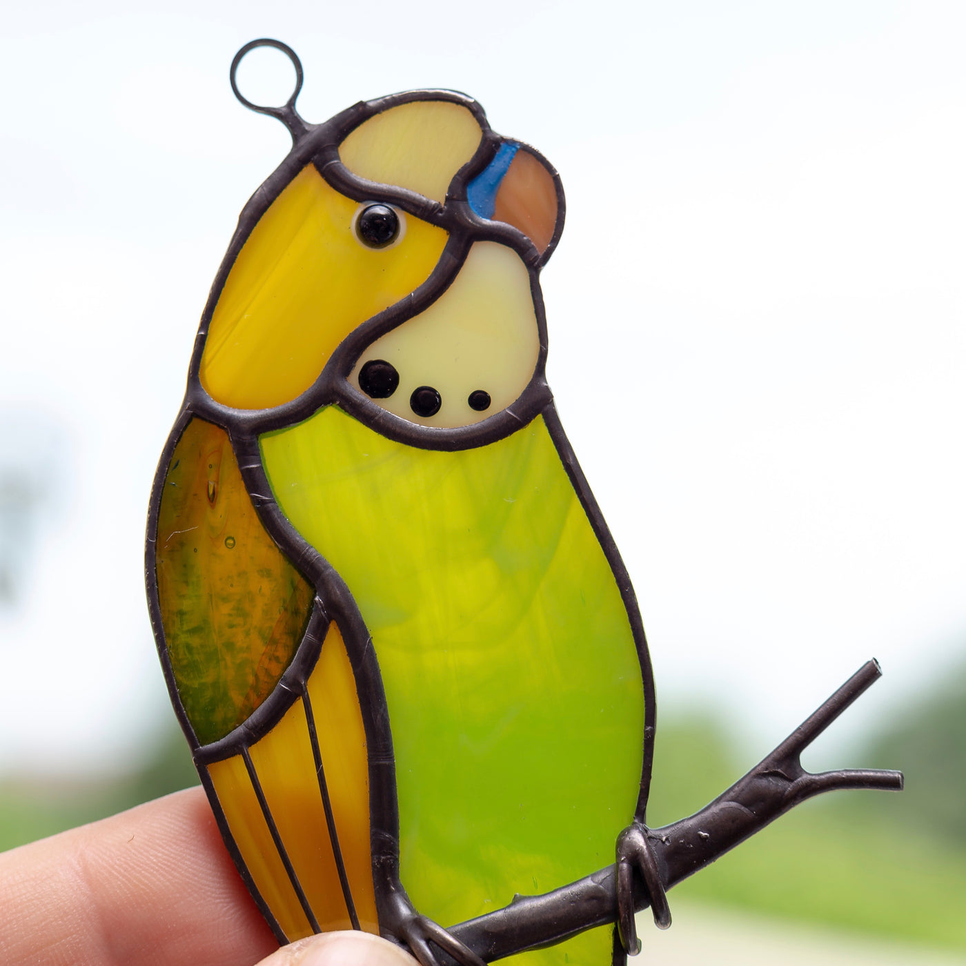 Zoomed stained glass green budgie window hanging