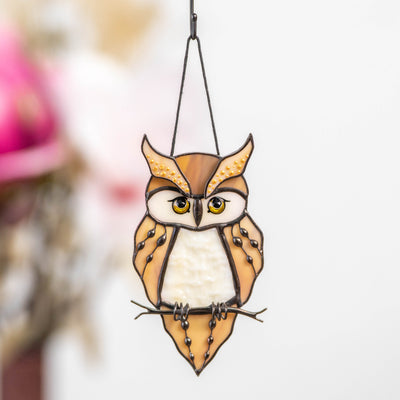 Stained glass great horned owl decor with soft indoor background