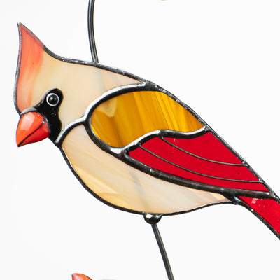 Closeup of stained glass cardinal hanging on the curve