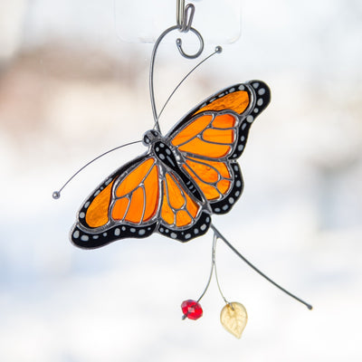 Detailed view of stained glass monarch butterfly, focusing on intricate wing pattern and craftsmanship.