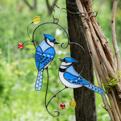 Stained glass bluejays suncatcher hanging on the tree