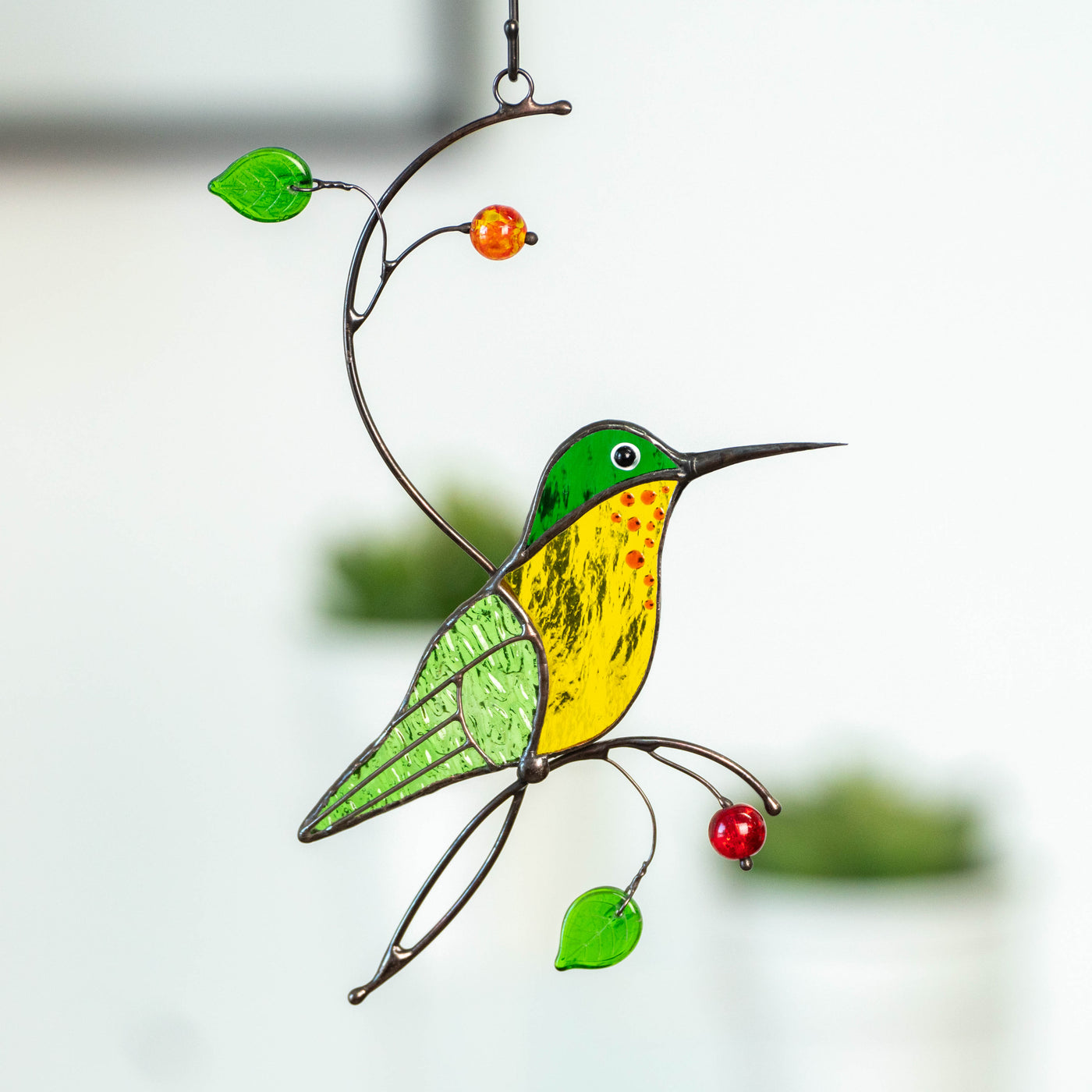 Stained glass green hummingbird with yellow belly window hanging