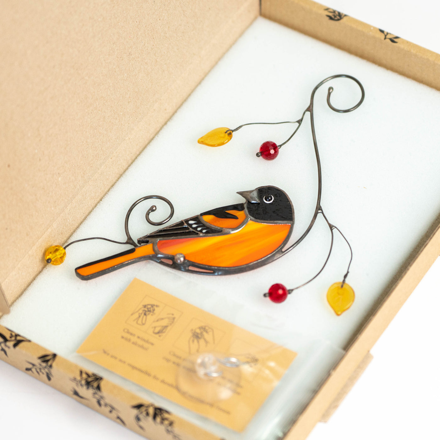 Stained glass looking left Baltimore oriole suncatcher in a brand box