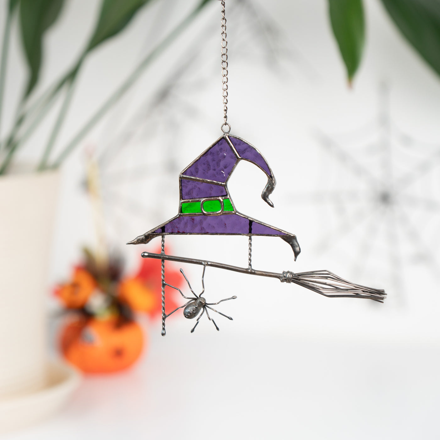 Purple witch's hat with broom and spider suncatcher of stained glass