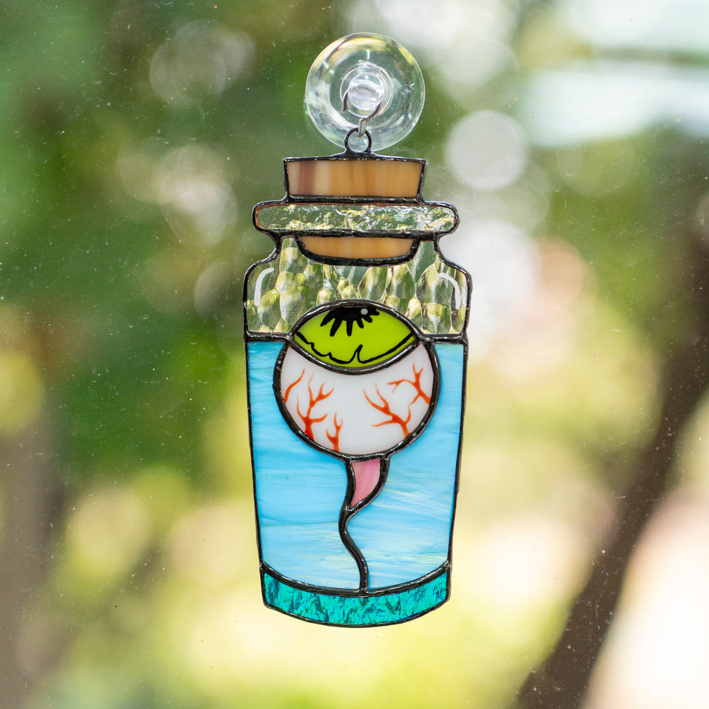 Stained glass torn out eye in the bottle suncatcher for Halloween decor