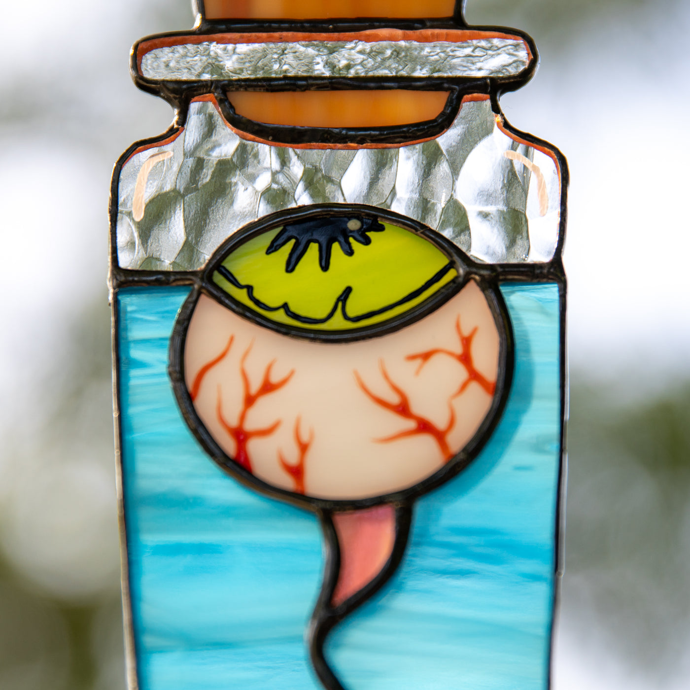 Zoomed stained glass eye in the bottle