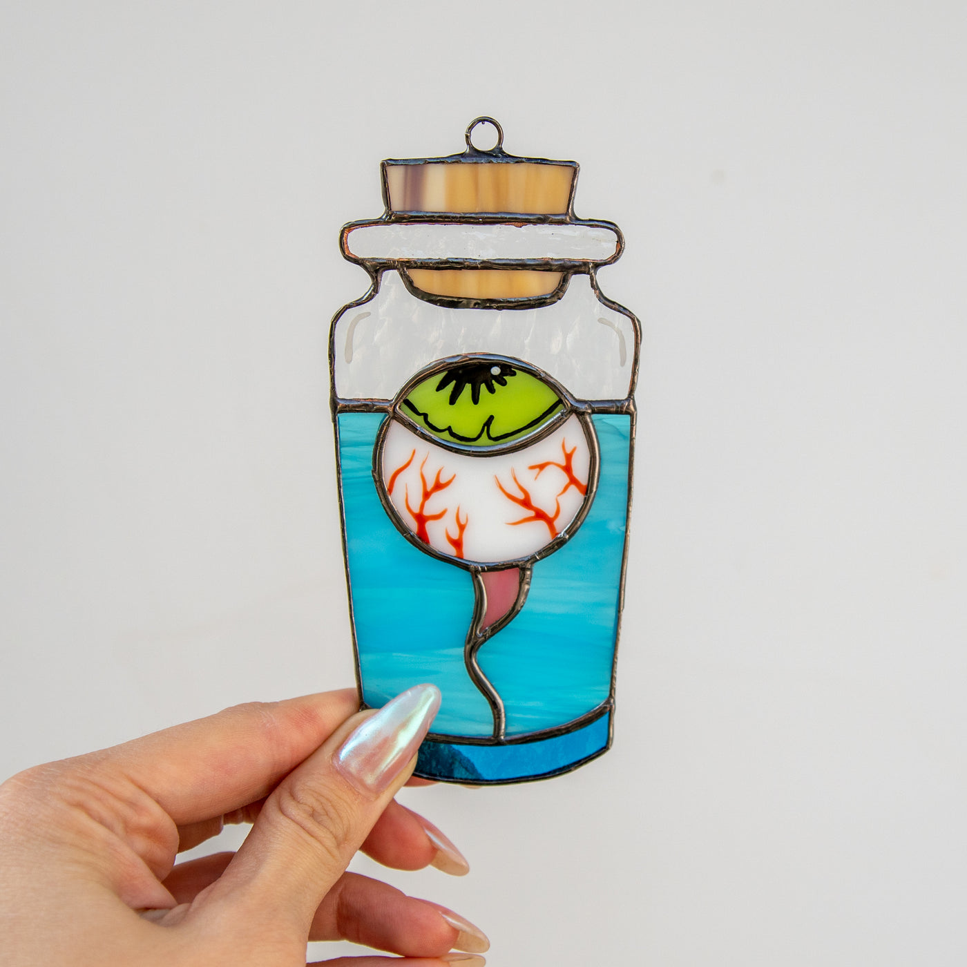 Stained glass torn out eye in the bottle suncatcher for spooky Halloween decor