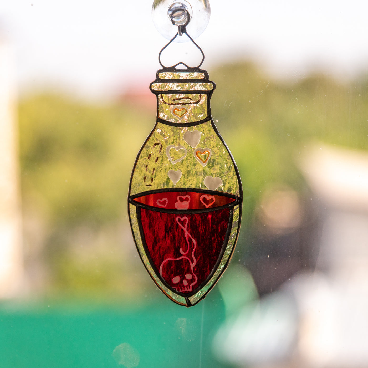 Halloween stained glass suncatcher of a bottle with blood