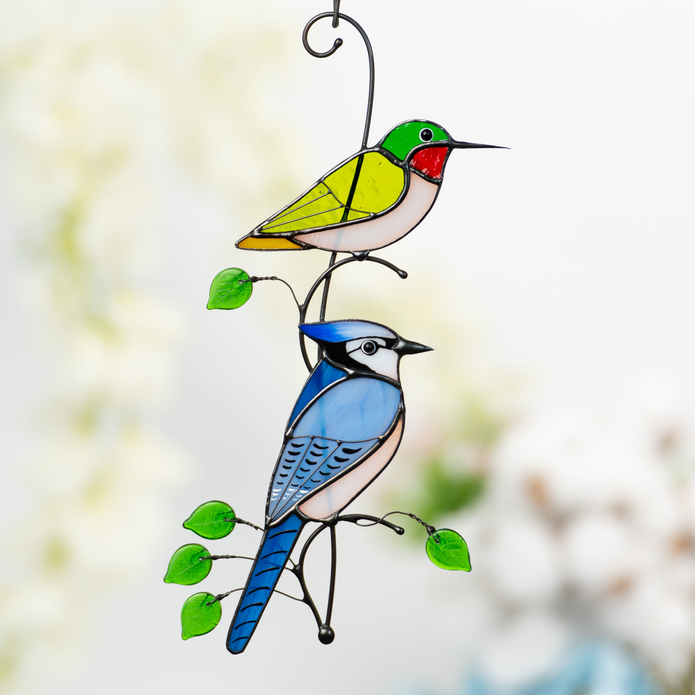 Green hummingbird and a bluejay suncatcher of stained glass