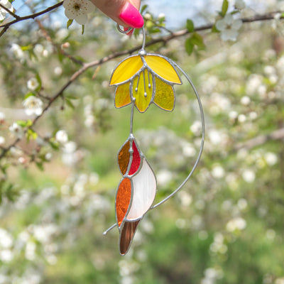 Golden hummingbird with yellow flower suncatcher of stained glass