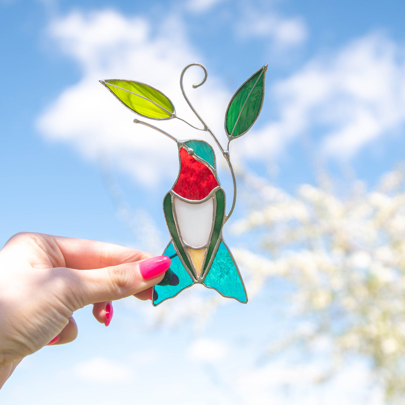 Bright turquoise ruby-throated stained glass hummingbird window hanging
