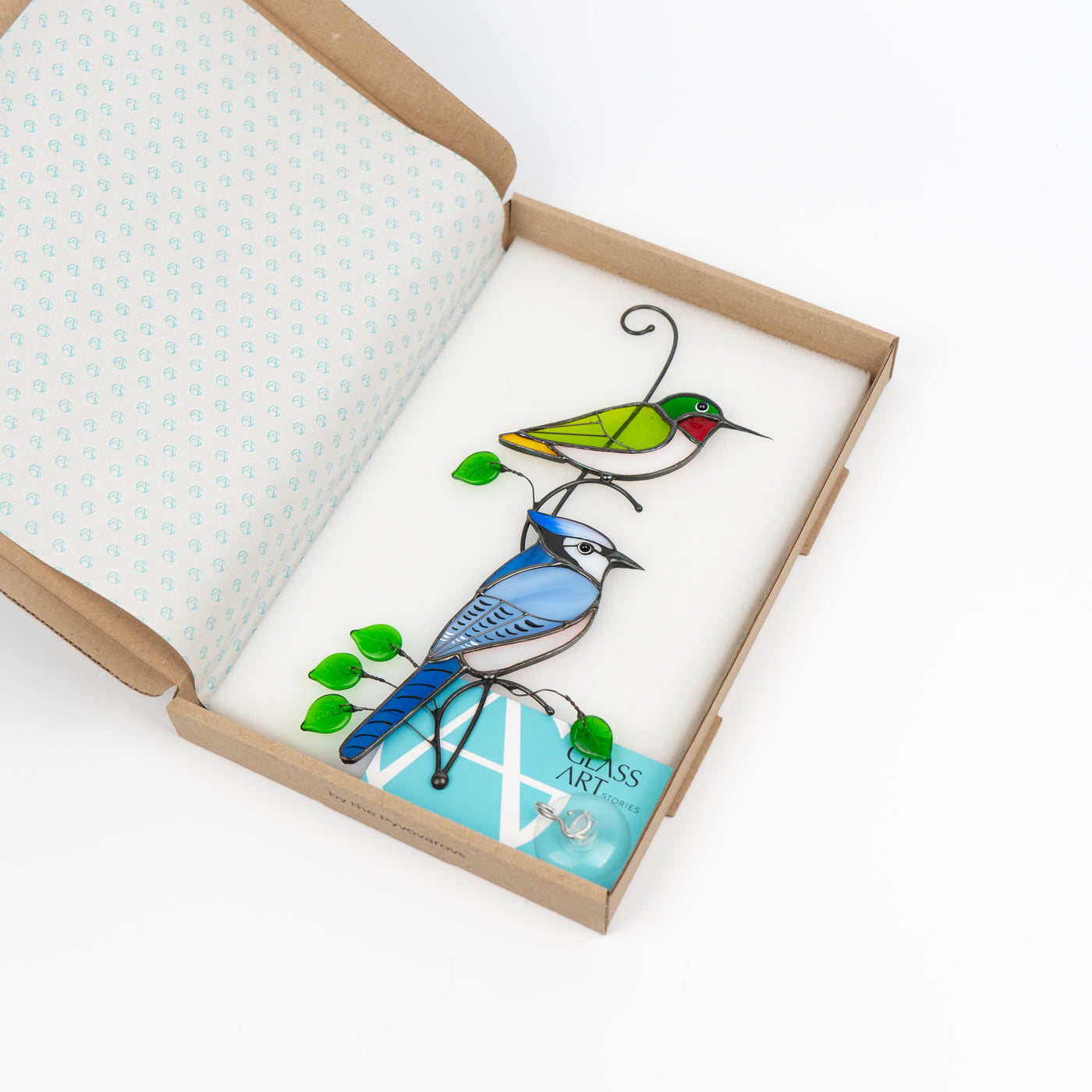 Stained glass hummingbird and blue jay suncatcher in a brand box
