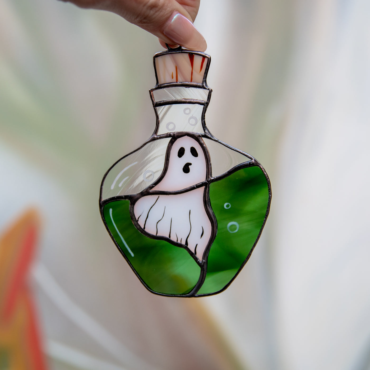 Ghost in the bottle with green liquid Halloween suncatcher of stained glass