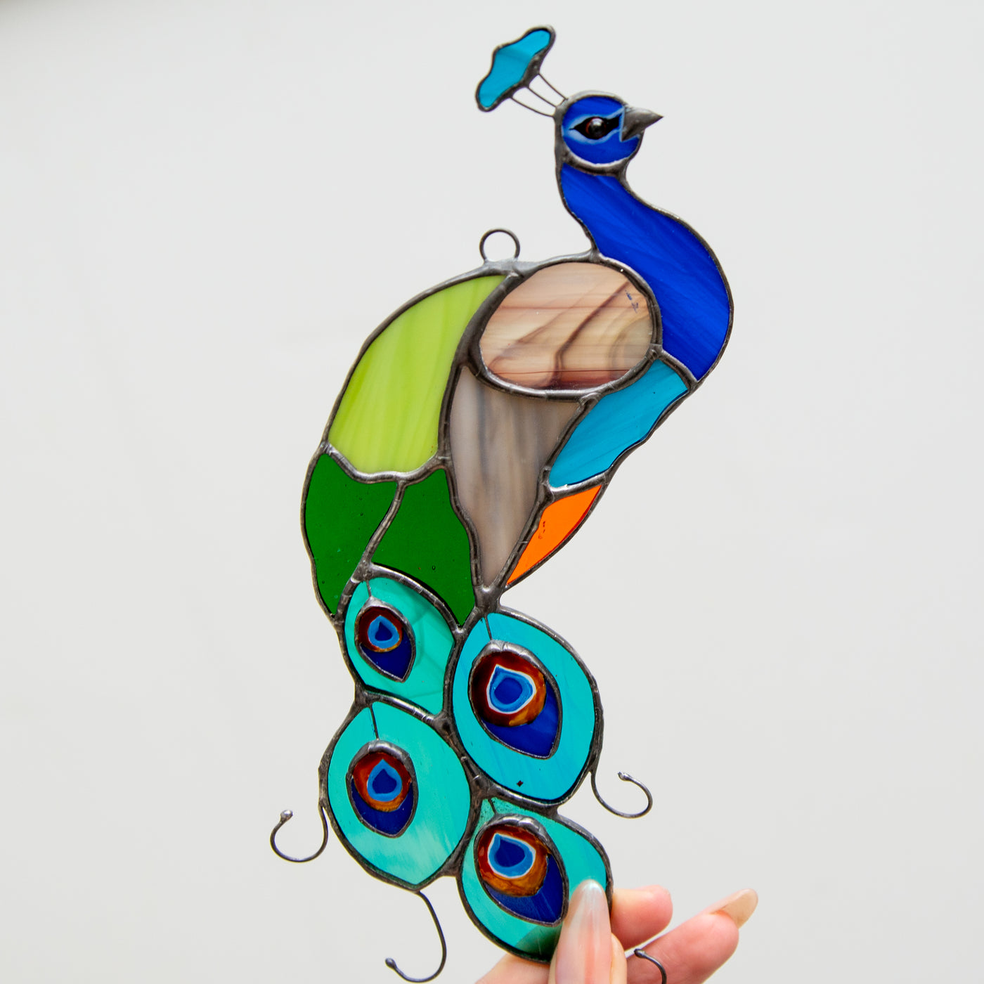 Colourful stained glass peacock window hanging