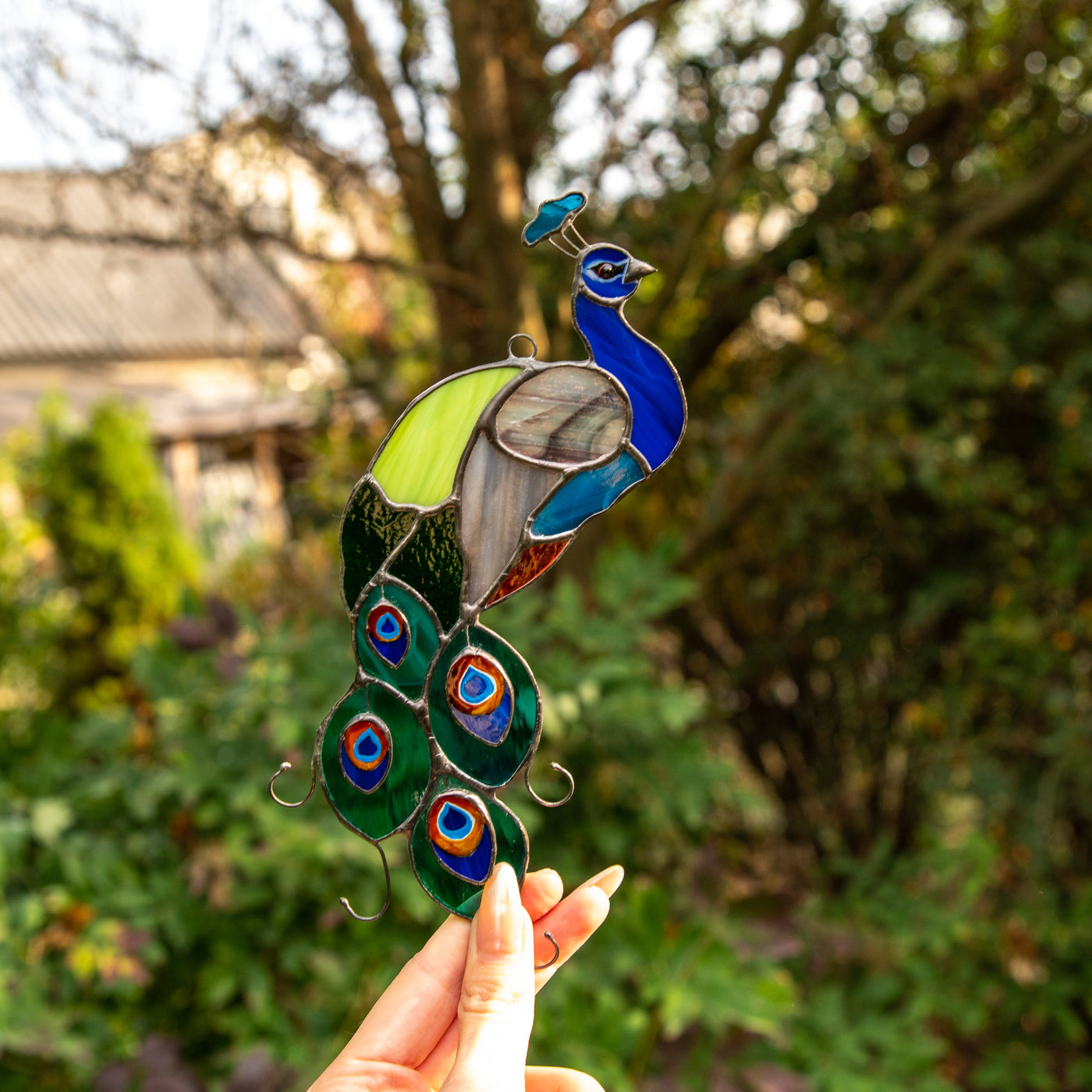 Stained glass peacock of bright colours suncatcher for window