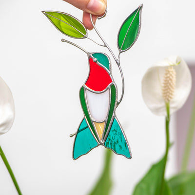 Stained glass ruby-throated hummingbird sitting on the branch suncatcher