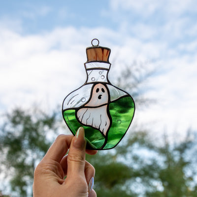 Creepy ghost in the bottle with green liquid suncatcher of stained glass 