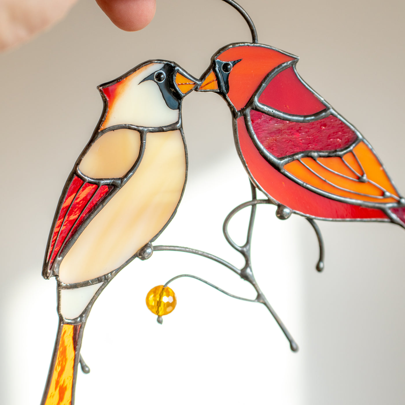 Zoomed stained glass cardinals kissing suncatcher