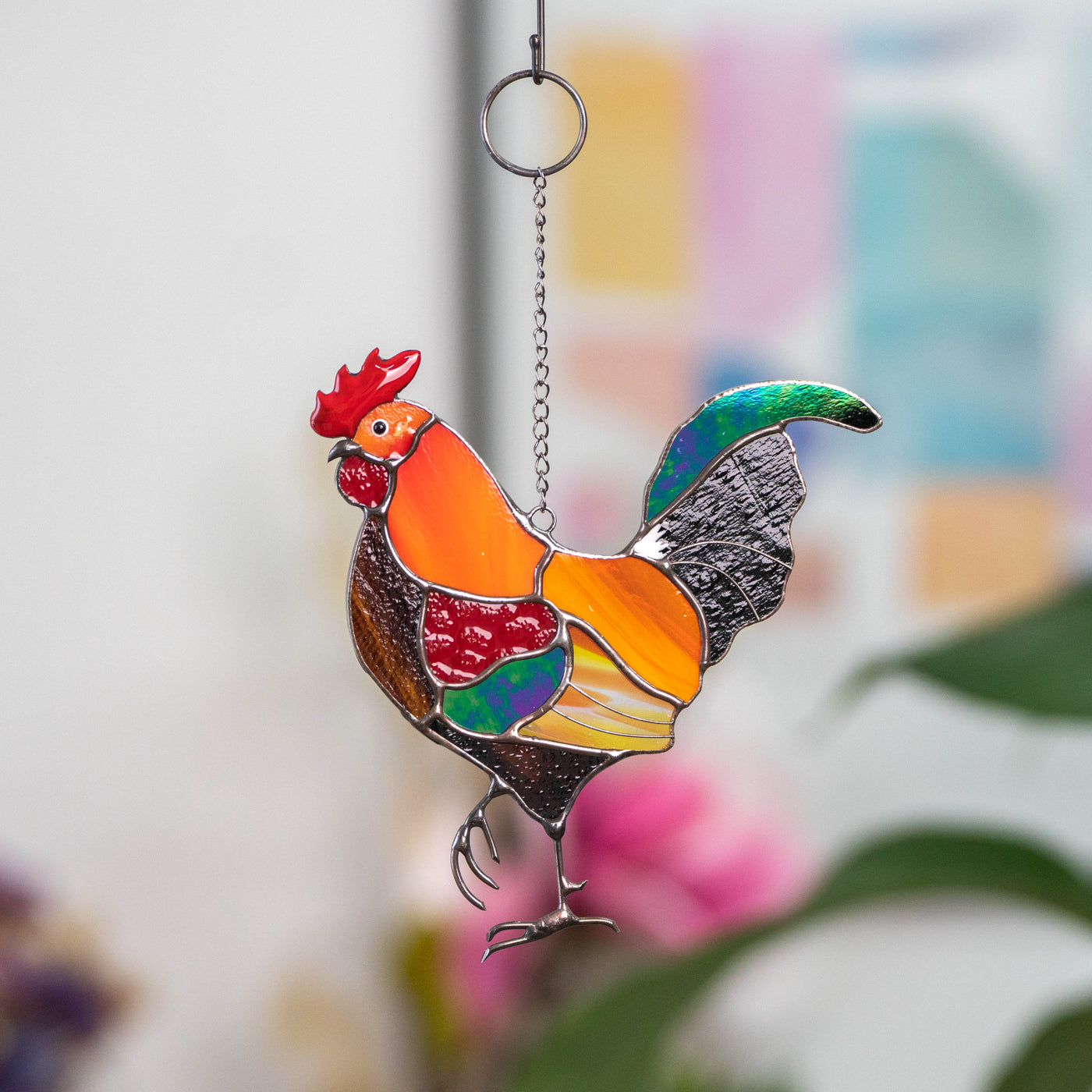 Stained glass window hanging of a rooster with iridescent tail