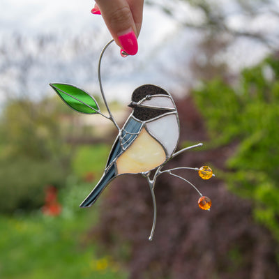 Stained glass chickadee looking left on the branch with leaf and berries suncatcher