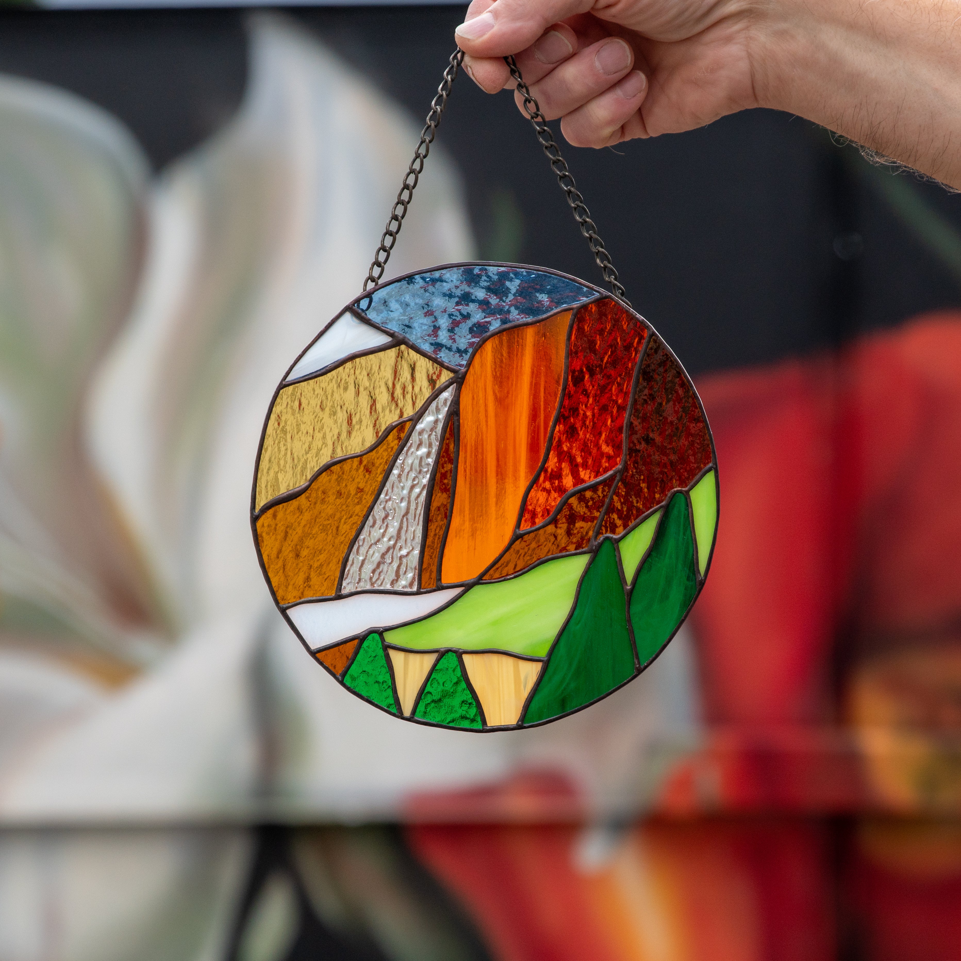 Round stained glass panel depicting Yosemite national park