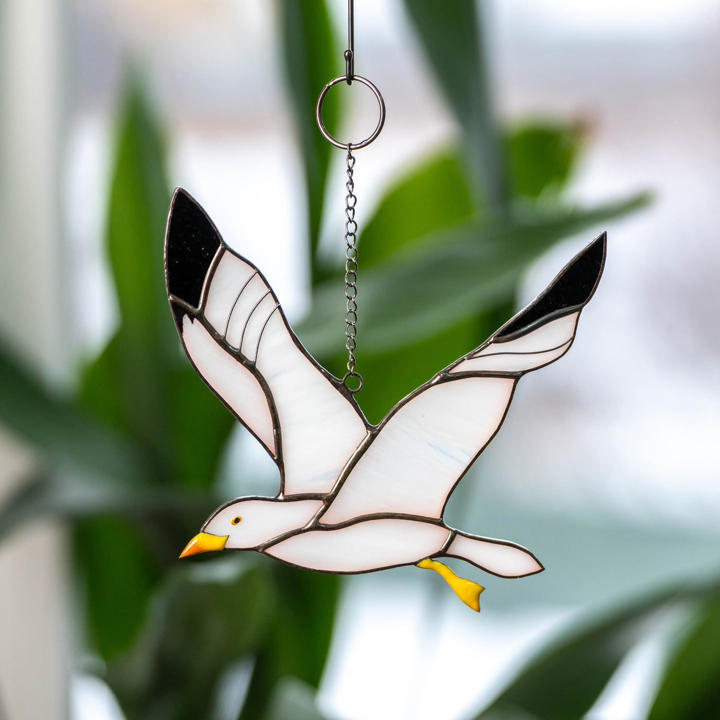Stained glass window hanging of a flying seagull