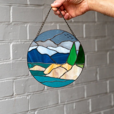 Stained glass panel depicting Lake Tahoe and its surrounding