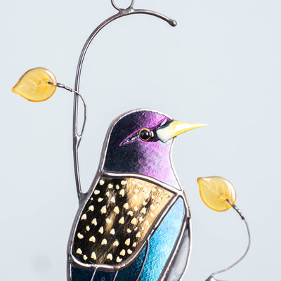 Zoomed stained glass European starling bird window hanging