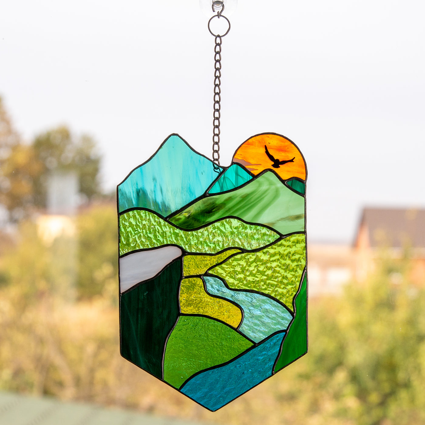 The highlands with the setting sun stained glass window hanging panel