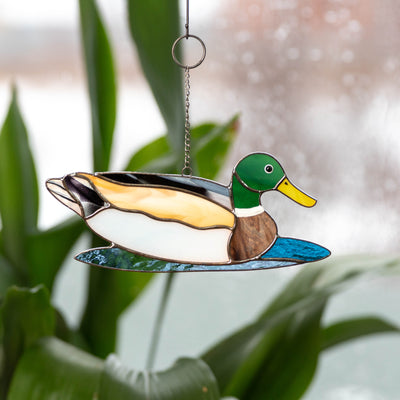 Stained glass window hanging of a swimming duck 