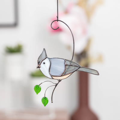 Tufted titmouse on the branch with leaves suncatcher of stained glass