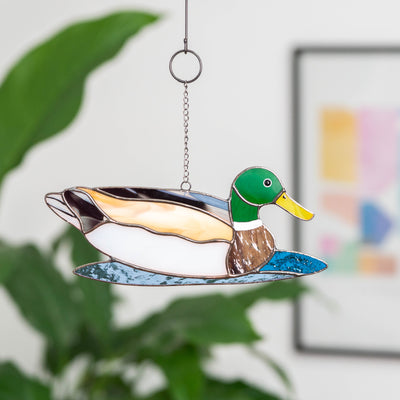 Stained glass window hanging of a swimming duck