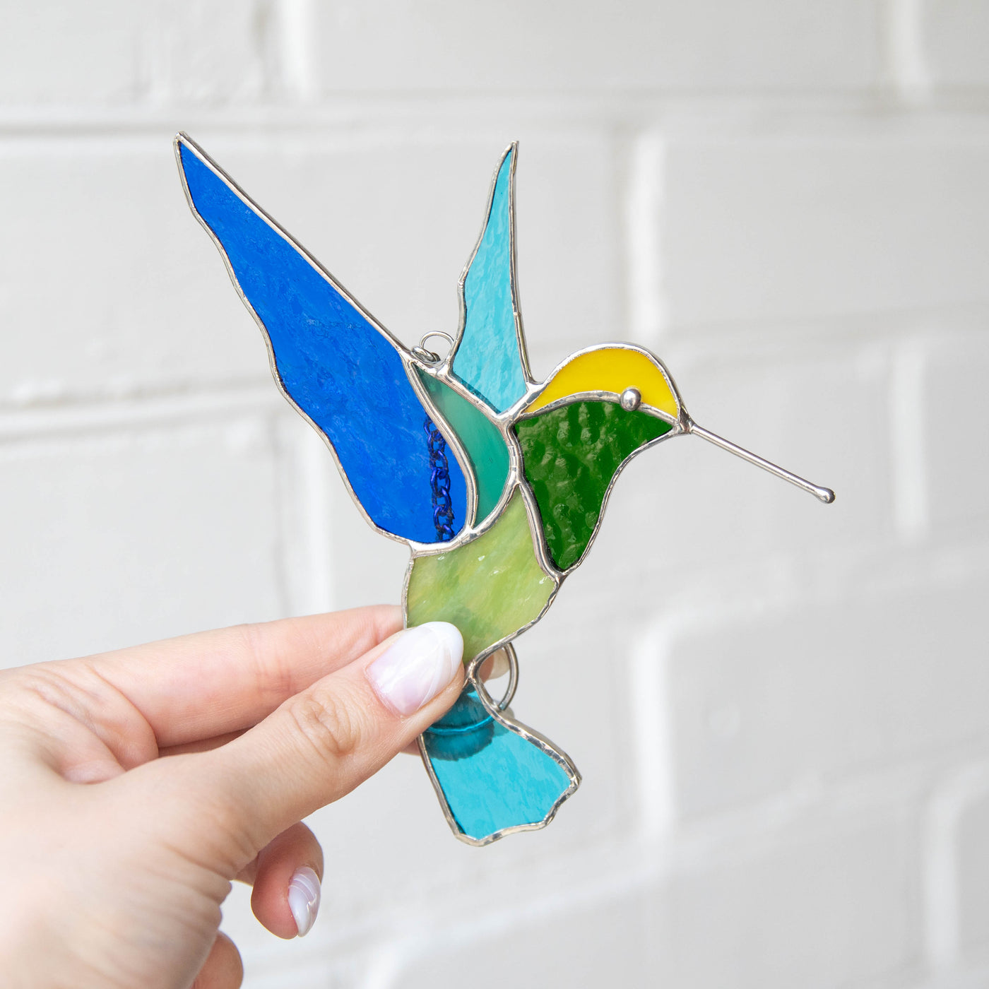 Green and turquoise hummingbird suncatcher of stained glass
