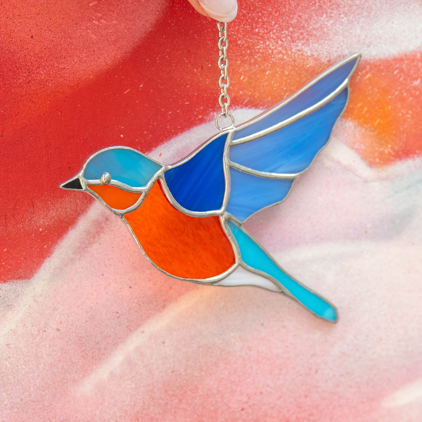 Zoomed stained glass flying bluebird suncatcher