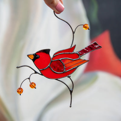 Male stained glass cardinal sitting on the branch window hanging