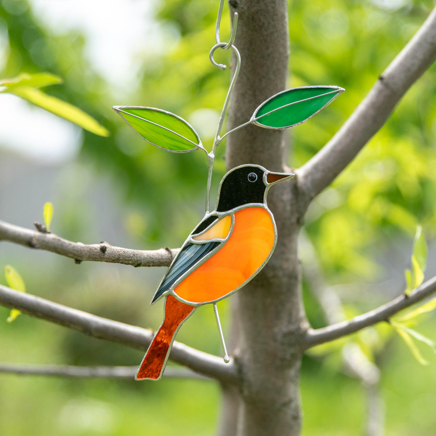 Stained glass Baltimore Oriole sitting on the branch suncatcher