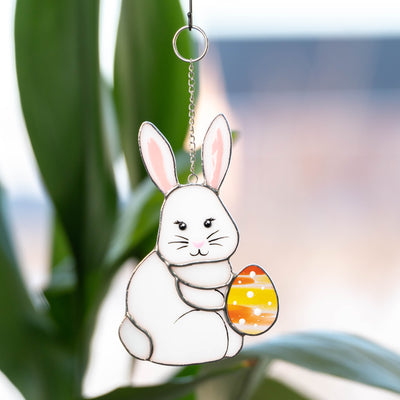 Easter bunny with an orange egg window hanging of stained glass